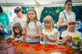 Small girls participating at art and craft outdoor workshop, playing with colorful chenille sticks